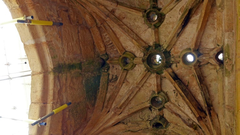 Murder holes with organic matter underneath in Bodiam Castle gatehouse with scaffolding